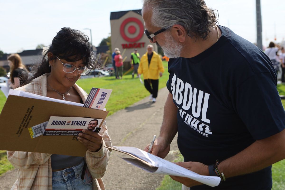 A campaign volunteer gathering signatures.